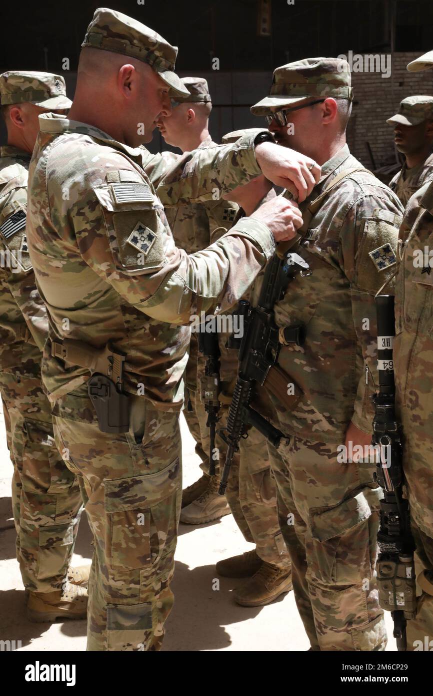 Lt. Col. Gregory Polk, the Task Force Pioneer commander, pins the Army ...