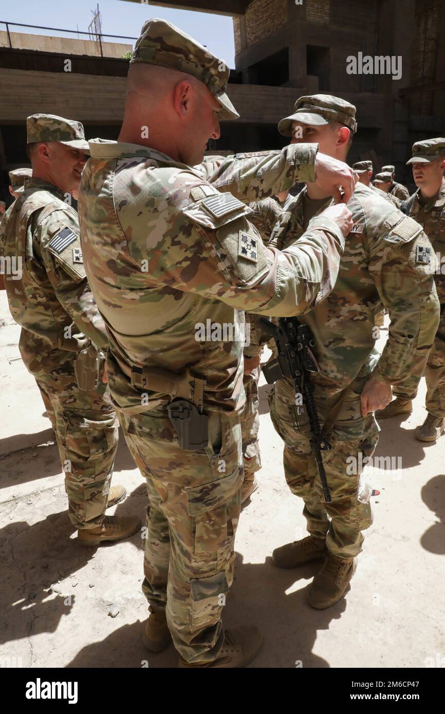 Lt. Col. Gregory Polk, the Task Force Pioneer commander, pins the Army ...