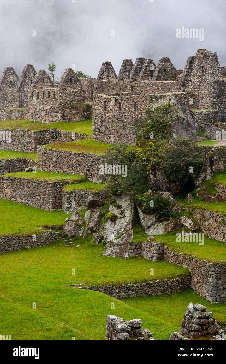 Machu Picchu ruins and green fields. Stock Photo