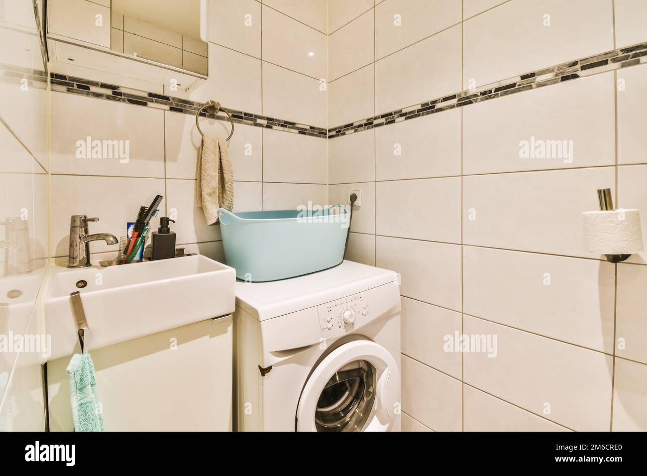 a laundry room with a washer and dryer on the wall next to the washing ...