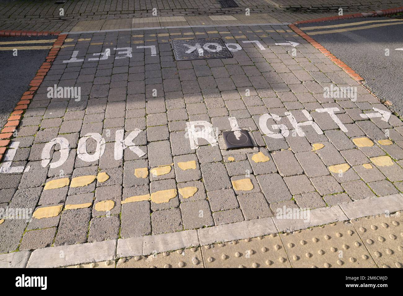 Detail of look right and look left road markings painted on a UK pedestrian road crossing Stock Photo