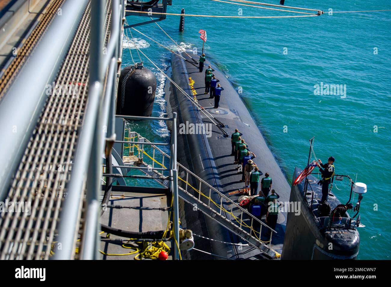 PERTH, Australia (April 23, 2022) Sailors assigned to the Los Angeles-class fast-attack submarine USS Springfield (SSN 761) observe the raising of the national ensign, April 23, 2022. Springfield is moored alongside the Emory S. Land-class submarine tender USS Frank Cable (AS 40) at HMAS Stirling Navy Base. Frank Cable is currently on patrol conducting expeditionary maintenance and logistics in support of national security in the U.S. 7th Fleet area of operations. Stock Photo