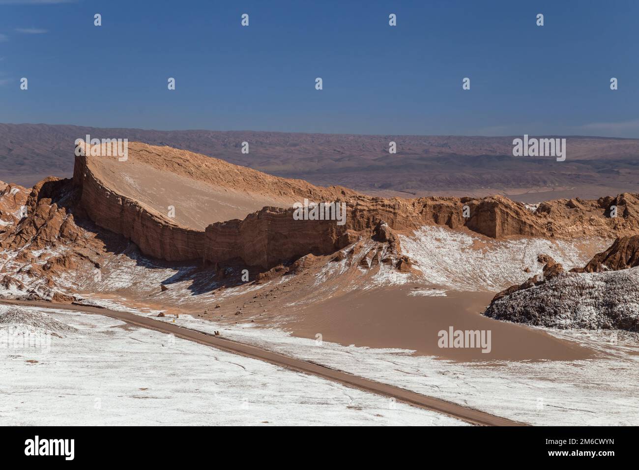 Dunes and rock formations covered with dry salt in Valle de la Luna, Atacama, Chile Stock Photo