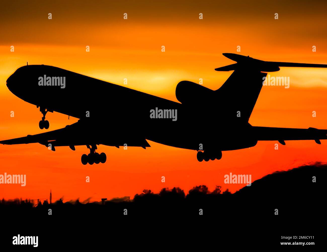 Takeoff of a passenger plane on the background of a sunset. Stock Photo