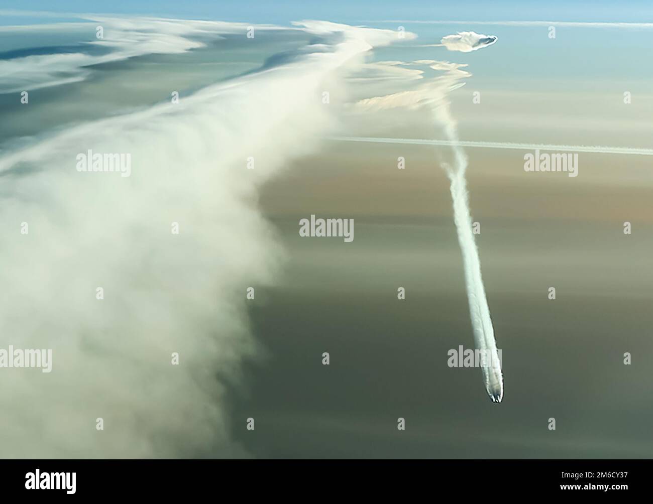 Condensation trail left by the aircraft during Stock Photo