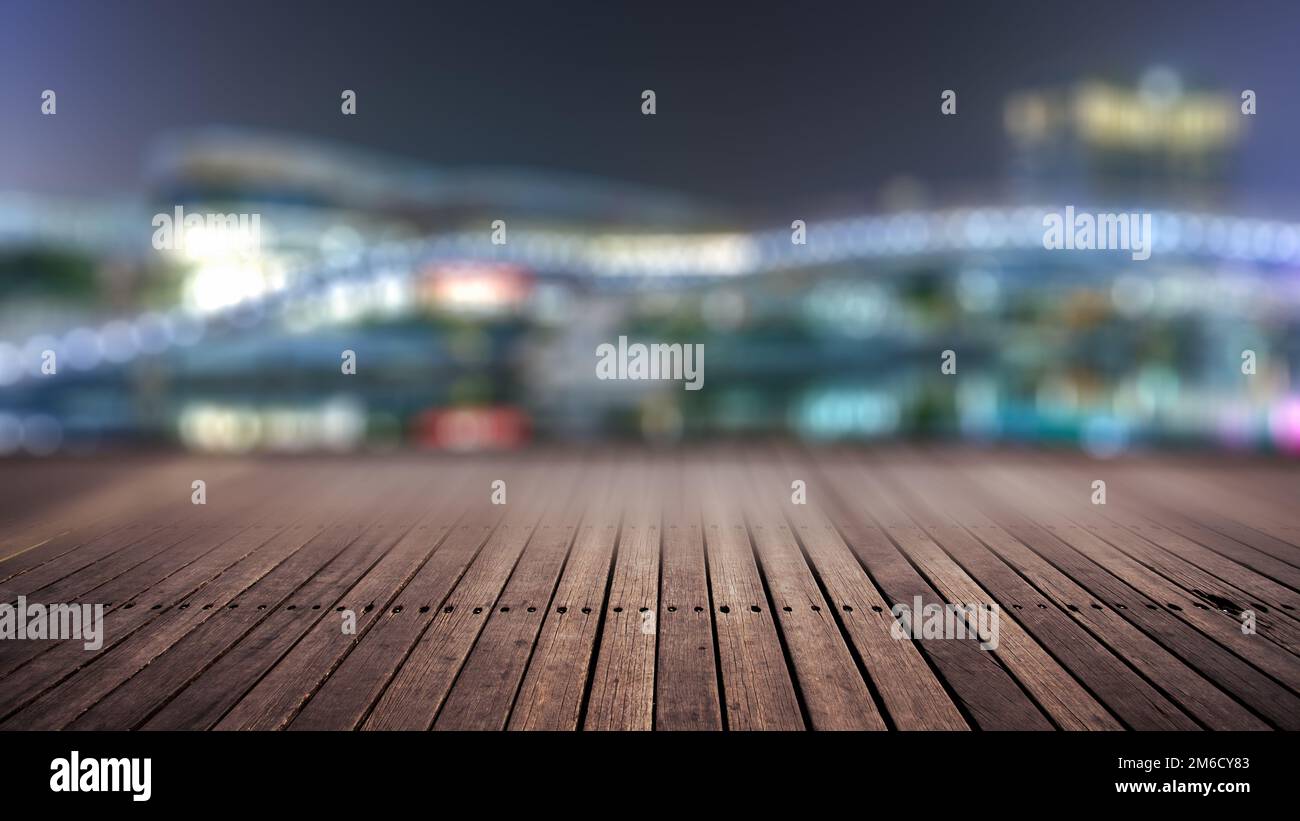 Wooden platform and lights of night city Stock Photo - Alamy