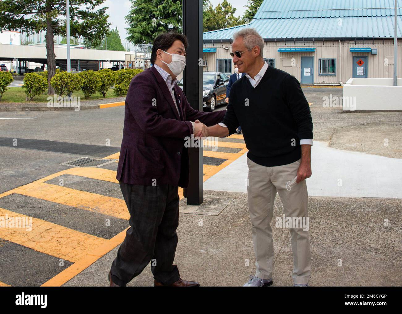 220423-N-DM318-1083 NAVAL AIR FACILITY ATSUGI, Japan (Apr. 23, 2022) The Honorable Rahm Emanuel, the U.S. ambassador to Japan, greets Yoshimasa Hayashi, Japan Minister of Foreign Affairs, during a stop at the base while en route, for an official visit, to the Nimitz-class aircraft carrier USS Abraham Lincoln (CVN-72). Naval Air Facility (NAF) Atsugi supports the combat readiness of Commander, Carrier Air Wing FIVE (CVW 5), Helicopter Maritime Strike Squadron FIVE ONE (HSM-51) and 30 other tenant commands and provides logistic support, coordination, and services to units assigned to the Western Stock Photo