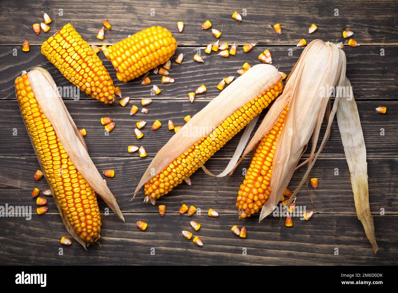 Corn Cobs And Seeds On Wooden Table Stock Photo