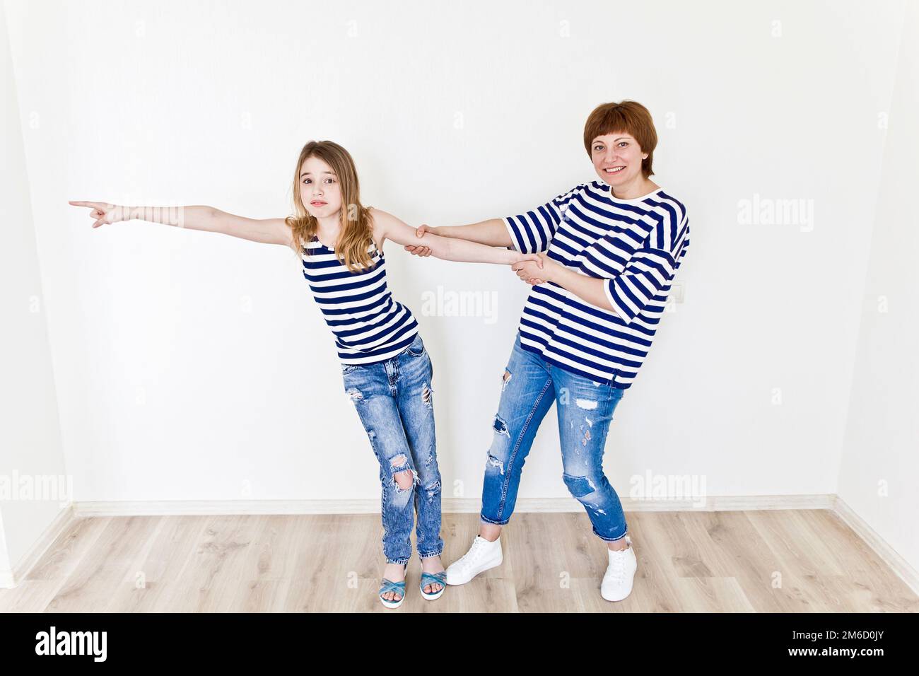 Beautiful mother and daughter on white Stock Photo - Alamy