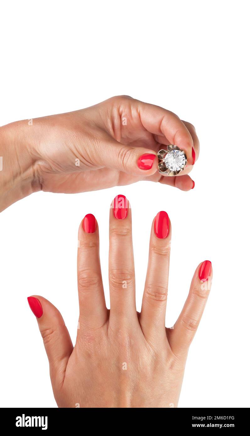 Female hands with red manicure wear a silver ring Stock Photo