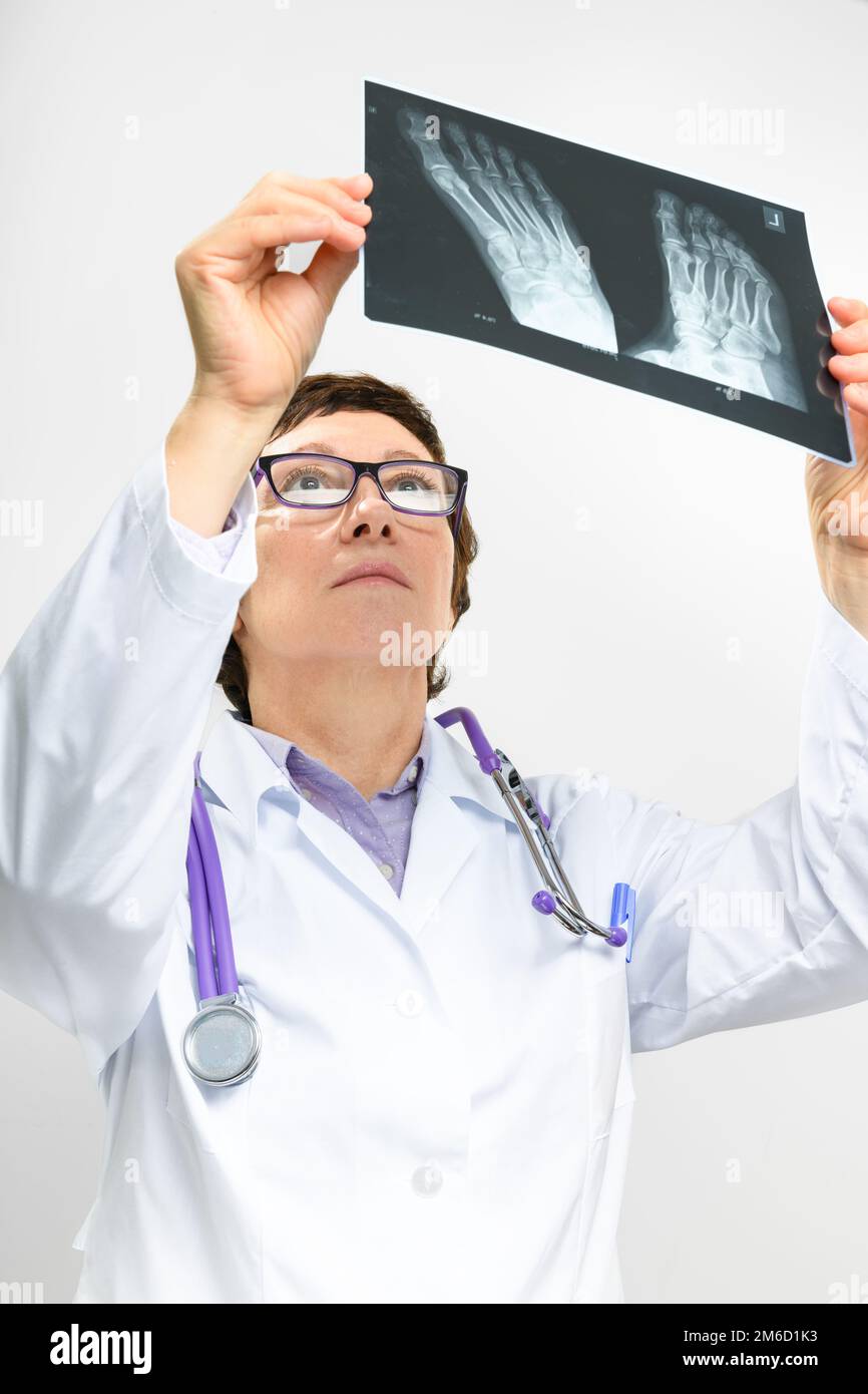 Doctor looking at x-ray of foot Stock Photo