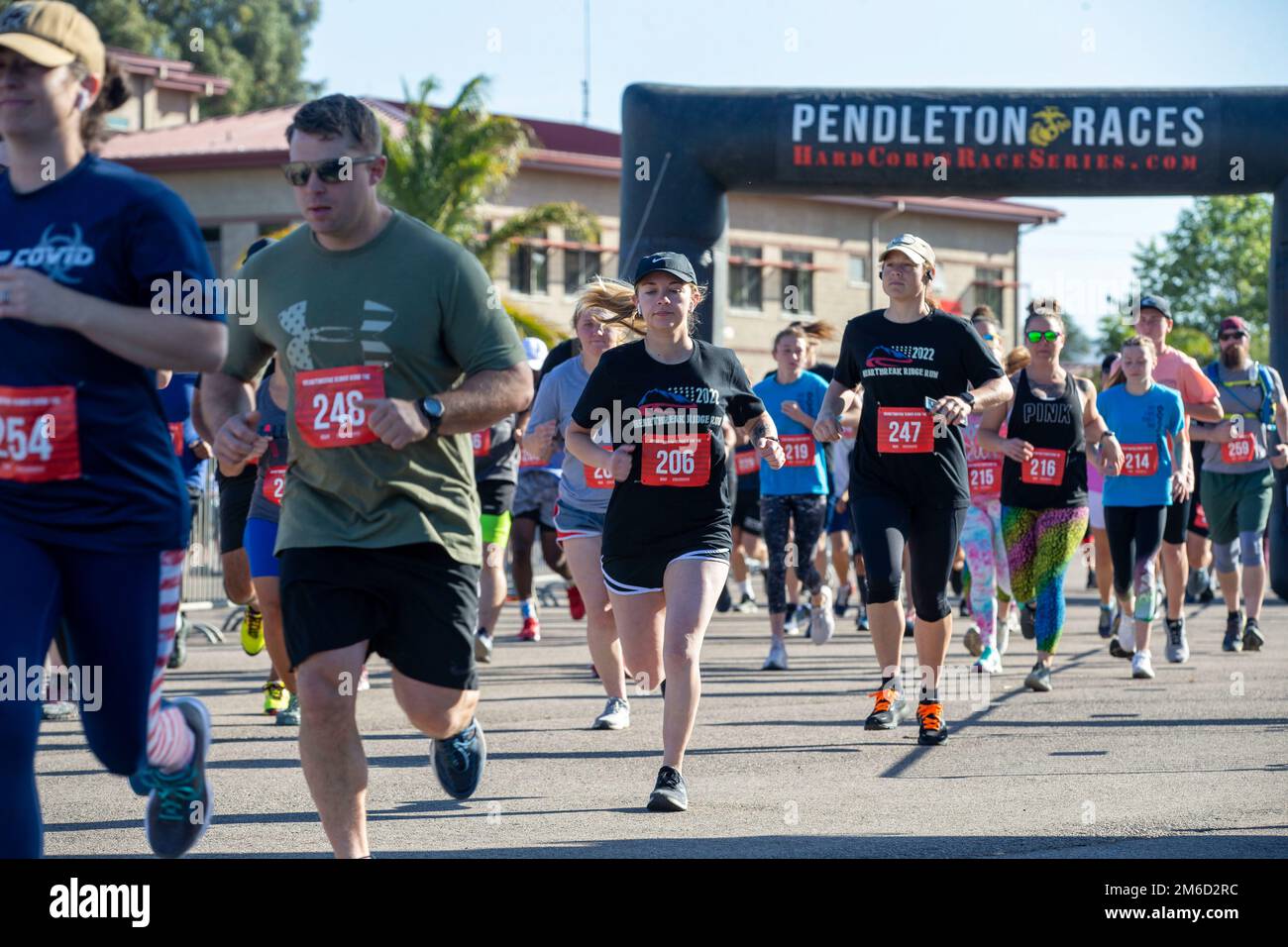 Marine Corps Base Camp Pendleton service members and their families participate in the 10-kilometer run event during the Heartbreak Ridge Run at the Las Pulgas parade deck on Camp Pendleton, California, April 23, 2022. The Heartbreak Ridge Run is part of Marine Corps Community Services Camp Pendletons’ Hard Corps Race Series, which offers multiple competitive races and family fitness events throughout the year for Camp Pendleton active duty service members, their dependents, retirees, and other authorized base patrons. Stock Photo