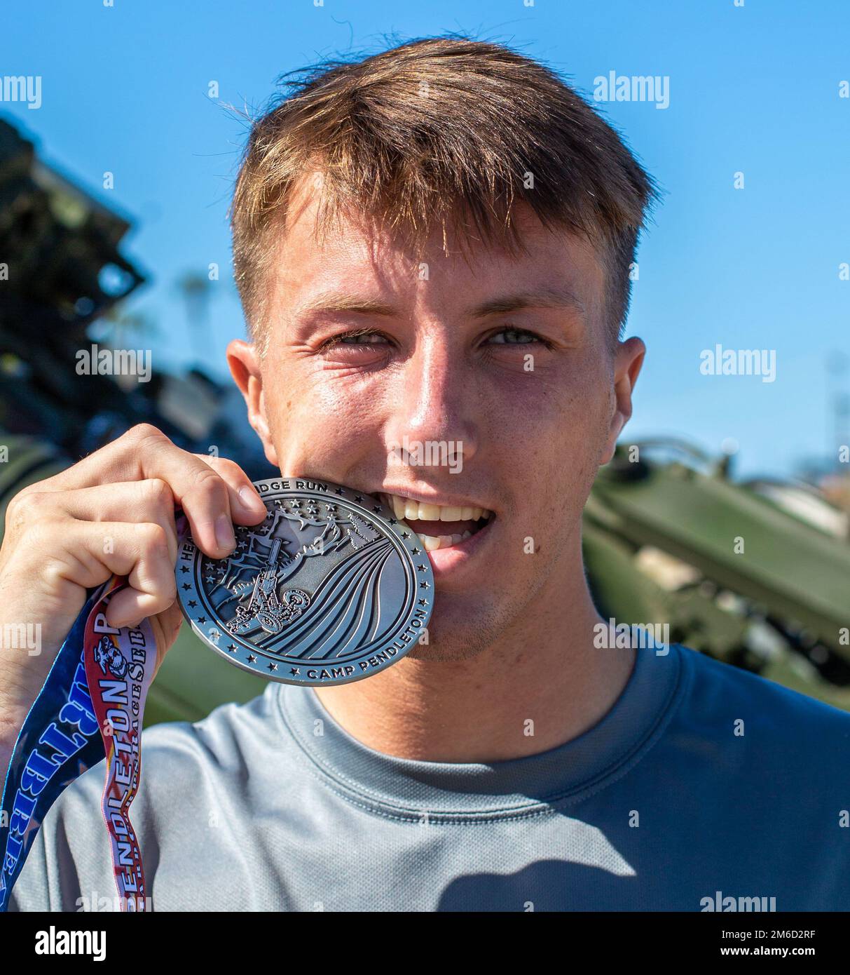 U.S. Marine Pvt. Zach Reinhard with 1st Supply Battalion, 1st Marine Logistics Group, shows his finisher medal for the 10-kilometer event during the Heartbreak Ridge Run at Las Pulgas parade deck on Marine Corps Base Camp Pendleton, California, April 23, 2022. The Heartbreak Ridge Run is part of the Marine Corps Community Services Camp Pendletons’ Hard Corps Race Series, which offers multiple different competitive races and family fitness events throughout the year explicitly for Camp Pendleton active duty service members, dependents, retirees, and other base patrons. Stock Photo