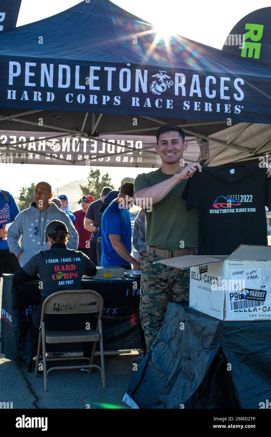 U.S. Marine Cpl. Maynor F. Levia, a helicopter airframe mechanic with Marine Light Attack Helicopter Squadron 469, Marine Aircraft Group 39, 3rd Marine Aircraft Wing, helps Camp Pendleton base patrons register for the Heartbreak Ridge Run at Las Pulgas parade deck on  Marine Corps Base Camp Pendleton, California, April 23, 2022. The Heartbreak Ridge Run is part of the Marine Corps Community Services Camp Pendletons’ Hard Corps Race Series, which offers multiple different competitive races and family fitness events throughout the year explicitly for Camp Pendleton active duty service members, d Stock Photo