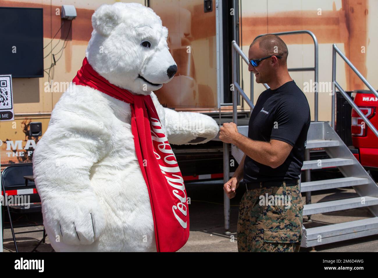 U.S. Marine Corps Staff Sgt. Justin M. Lundy, fist bumps the CocaCola polar bear mascot during