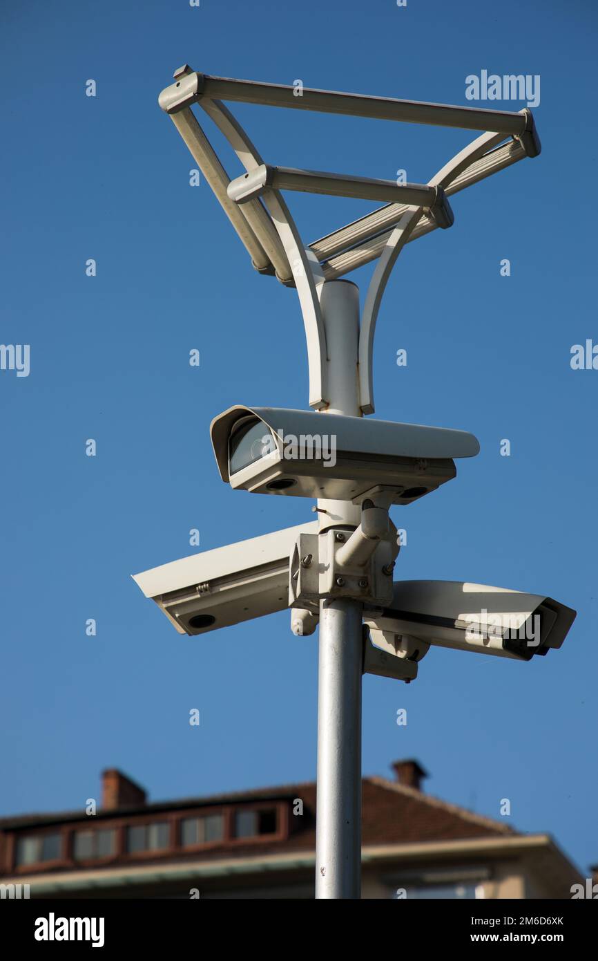 Security camera record lives, a Security camera on blue sky background. Stock Photo
