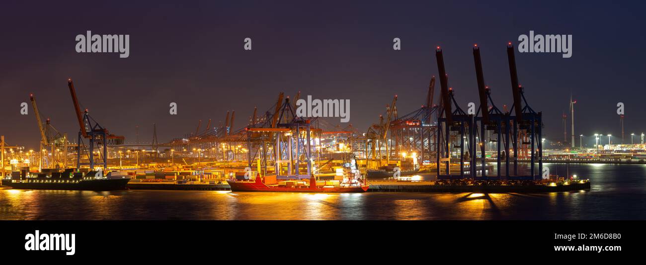 Panorama of a container terminal in the port of Hamburg at night Stock Photo