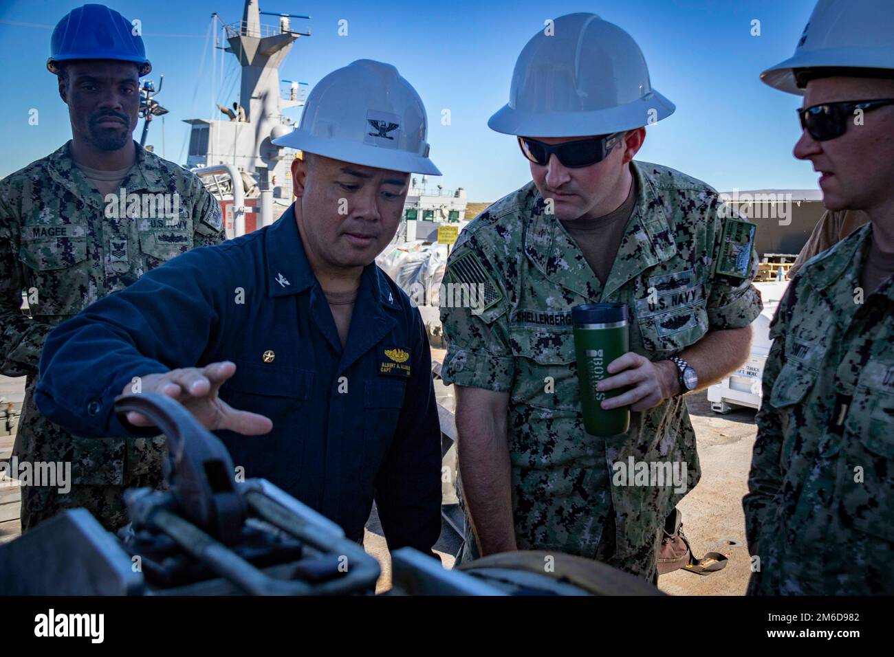 PERTH, Australia (April 24, 2022) - Capt. Albert Alarcon, commanding officer of the Emory S. Land-class submarine tender USS Frank Cable (AS 40), and Lt. Brandon Shellenberger, Frank Cable's weapons officer, discuss procedures of an expeditionary rearming exercise with the Los Angeles-class fast-attack submarine USS Springfield (SSN 761) at HMAS Stirling Navy Base on Garden Island off the coast of Perth, Australia, April 24, 2022. Springfield is currently moored alongside Frank Cable conducting expeditionary rearming exercises with Frank Cable and the Royal Australian Navy. Frank Cable is curr Stock Photo