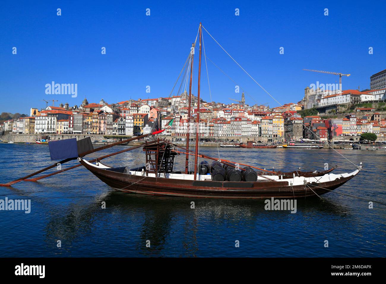 Traditional rabelo boats, Porto city skyline, Douro river and and Dom Luis or Luiz iron bridge. Porto Stock Photo