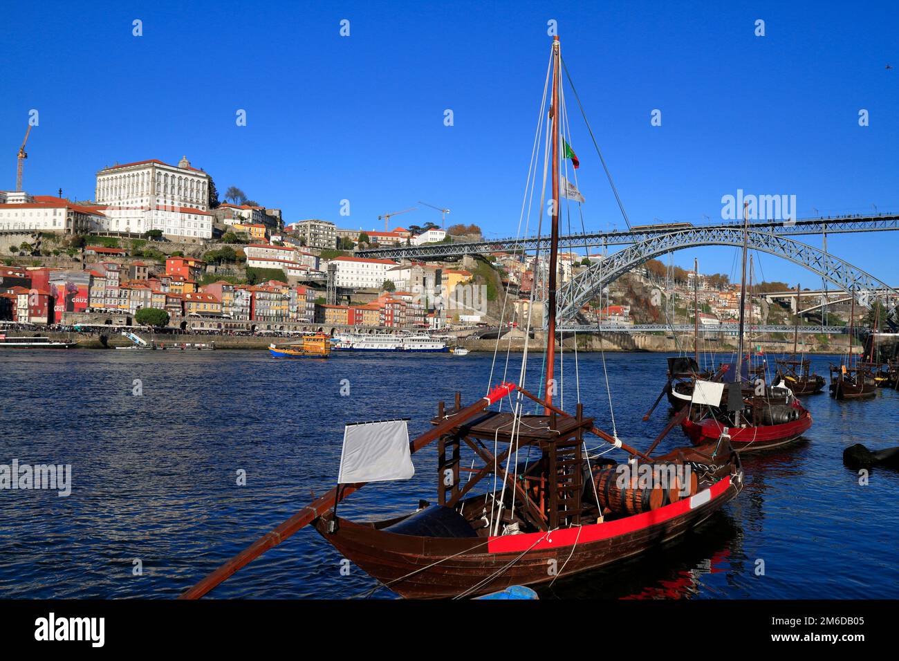 Traditional rabelo boats, Porto city skyline, Douro river and and Dom Luis or Luiz iron bridge. Porto Stock Photo