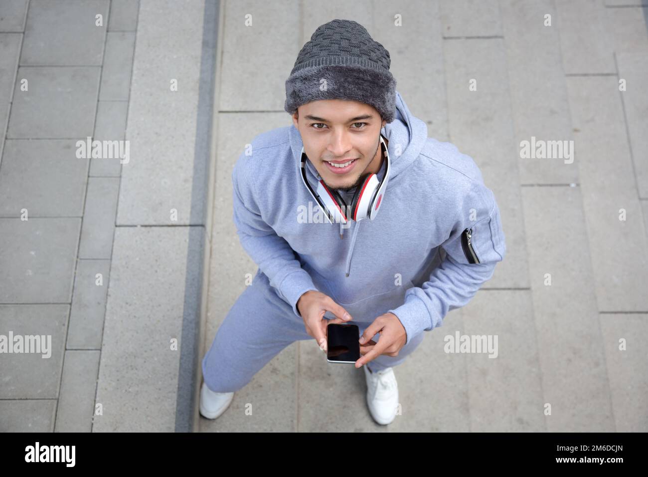 Smiling young latin man runner winter sports training from above Stock Photo