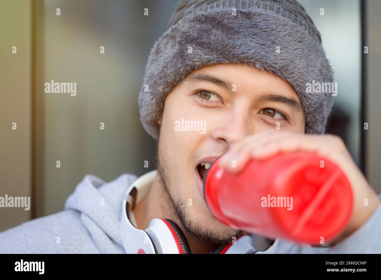 Sports training fitness young latin man drinking copyspace copy space winter running jogging Stock Photo