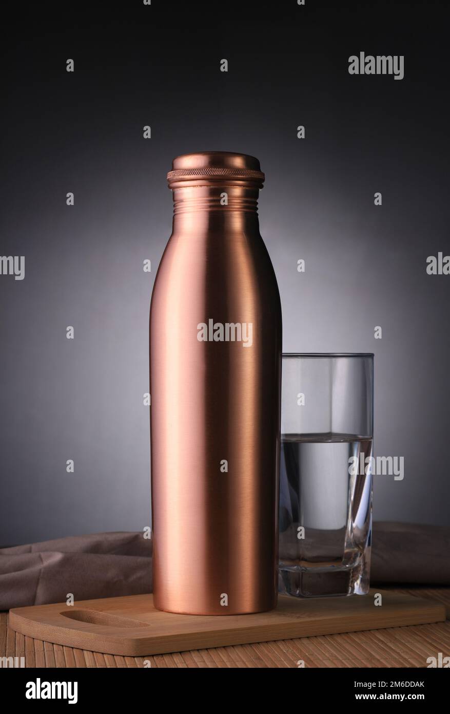 Copper Water Bottle and Glass of Water for Environment Friendly Use Stock Photo