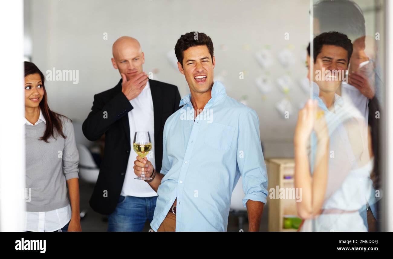 Social suicide - drinking himself into a stupor. A drunk man with a glass of wine in his hand at a office social. Stock Photo