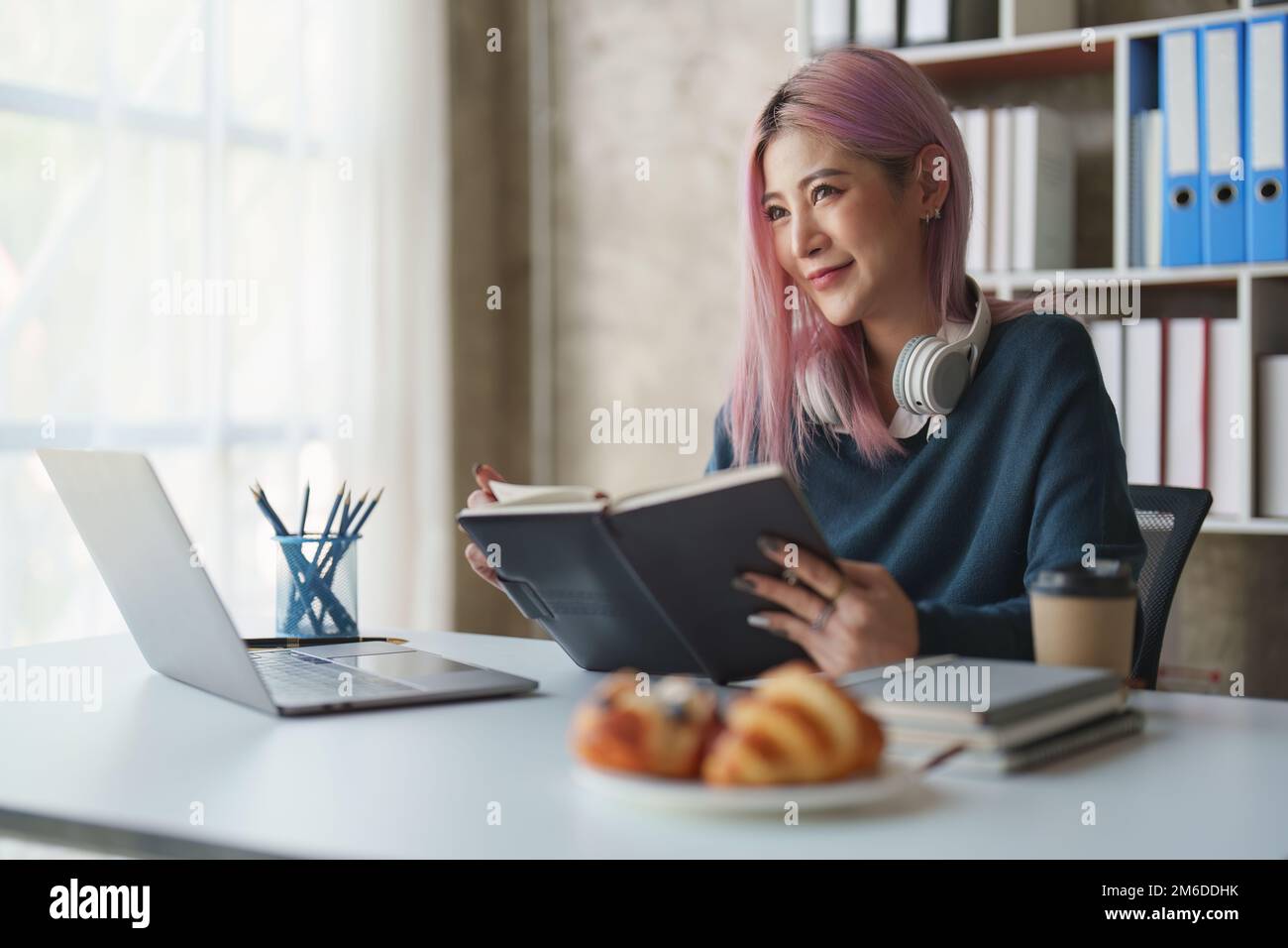 Beautiful Asian Woman read a book at home. The style lifestyle and concept of people enjoying life at home Stock Photo