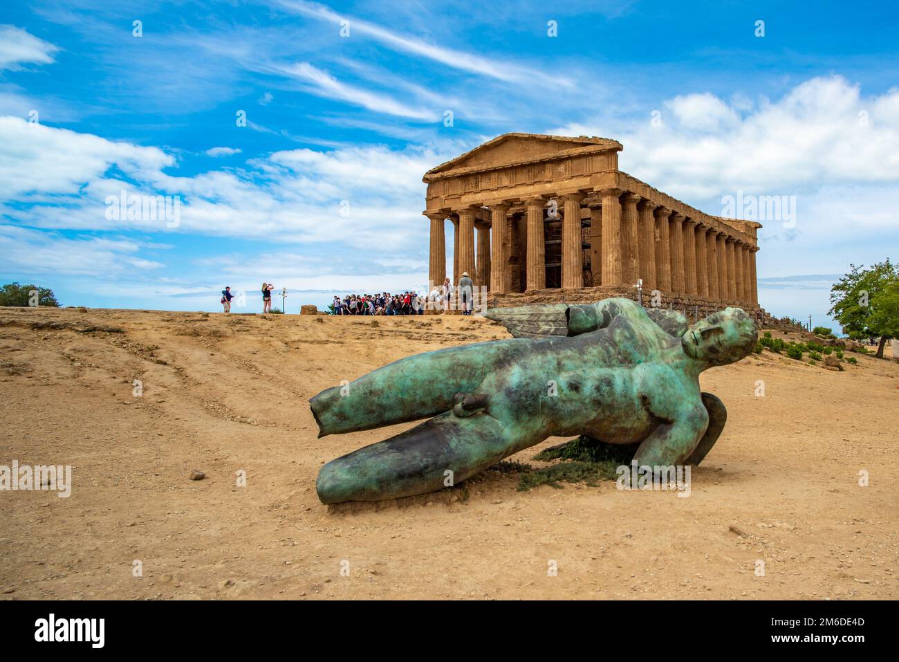 Temple of Concordia and the statue of Fallen Icarus, in the Valley of the Temples, Agrigento, Sicily, Italy Stock Photo