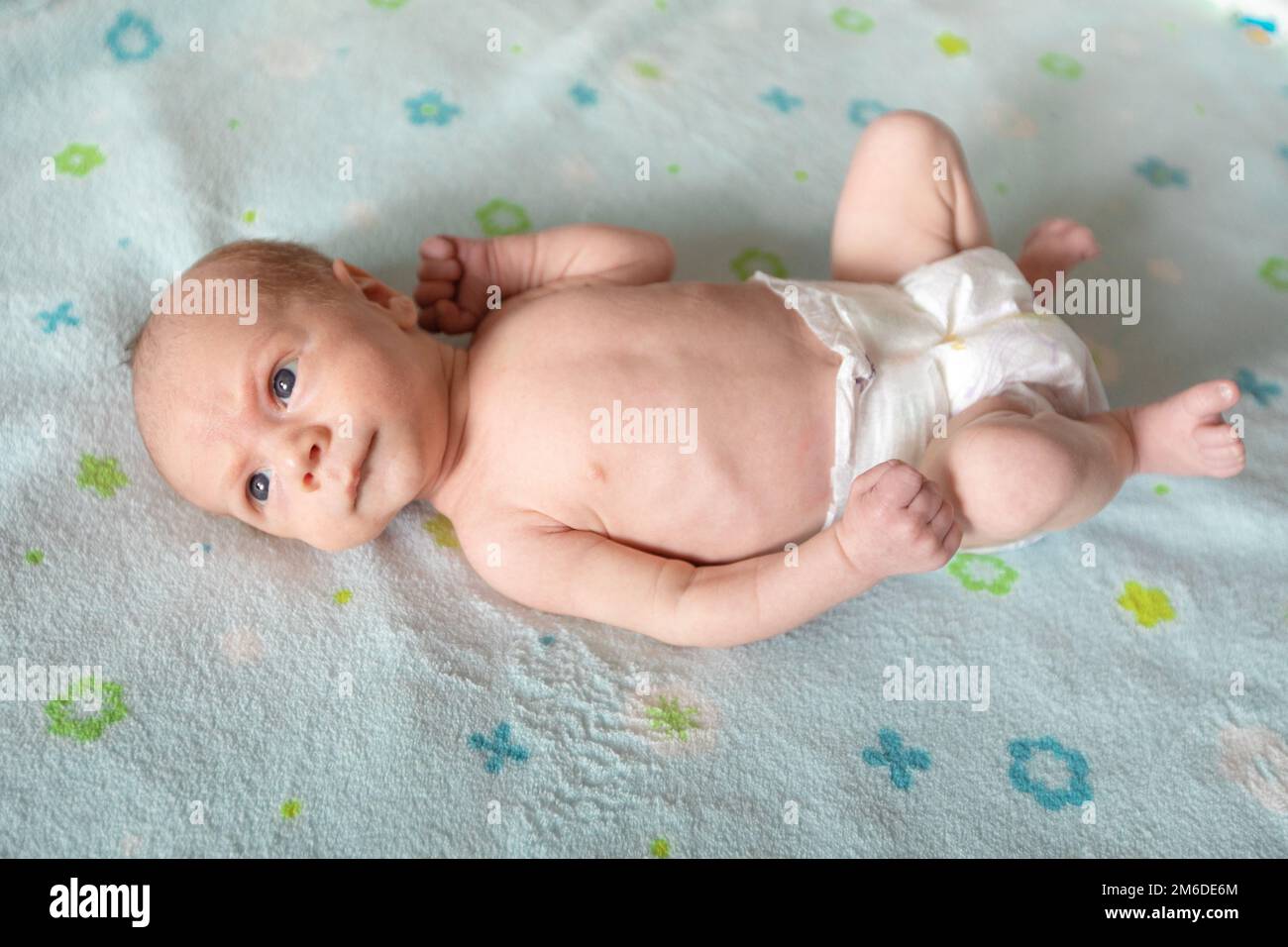 Lying on the bed sheet baby at home Stock Photo Alamy