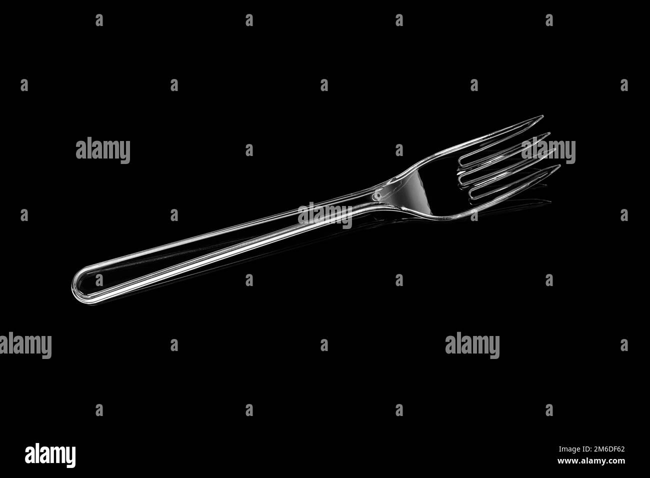 Transparent plastic fork isolated on black background Stock Photo