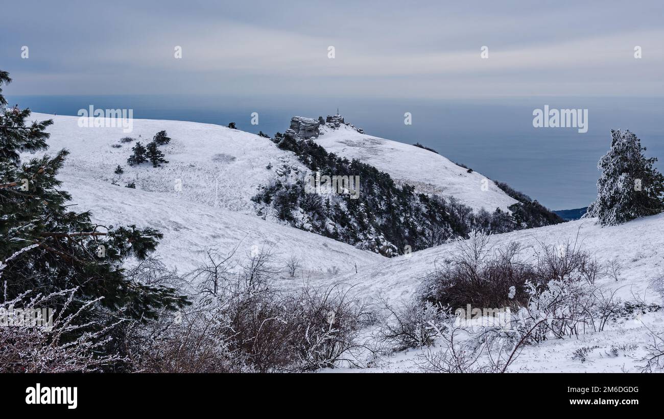 View on the top of Mount Alenga. Southern Demerdzhi in snow and ice early spring. Crimea Stock Photo