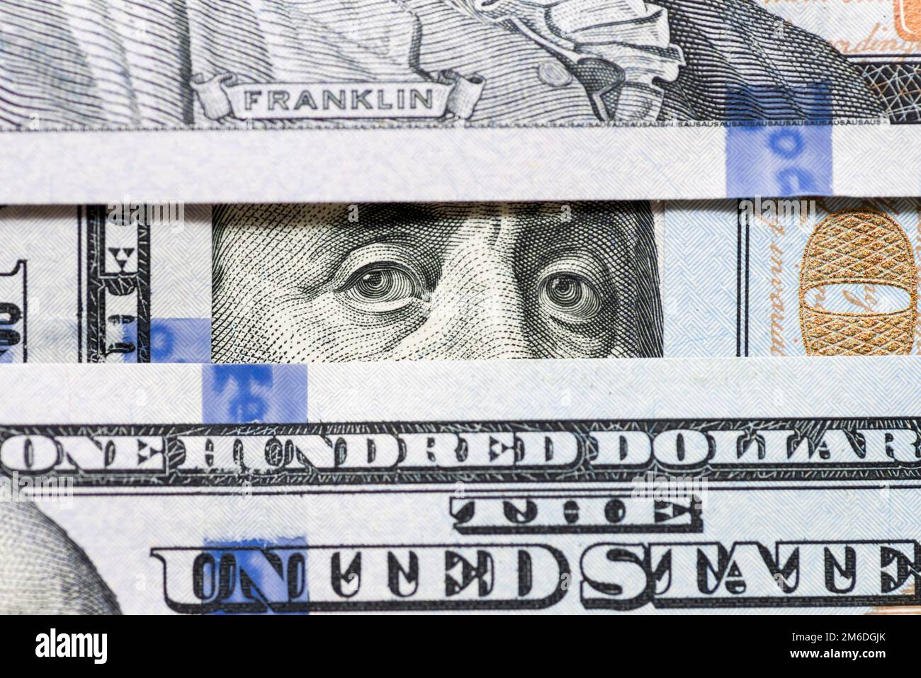 Eyes of Benjamin Franklin watching from stack of money windows Stock ...