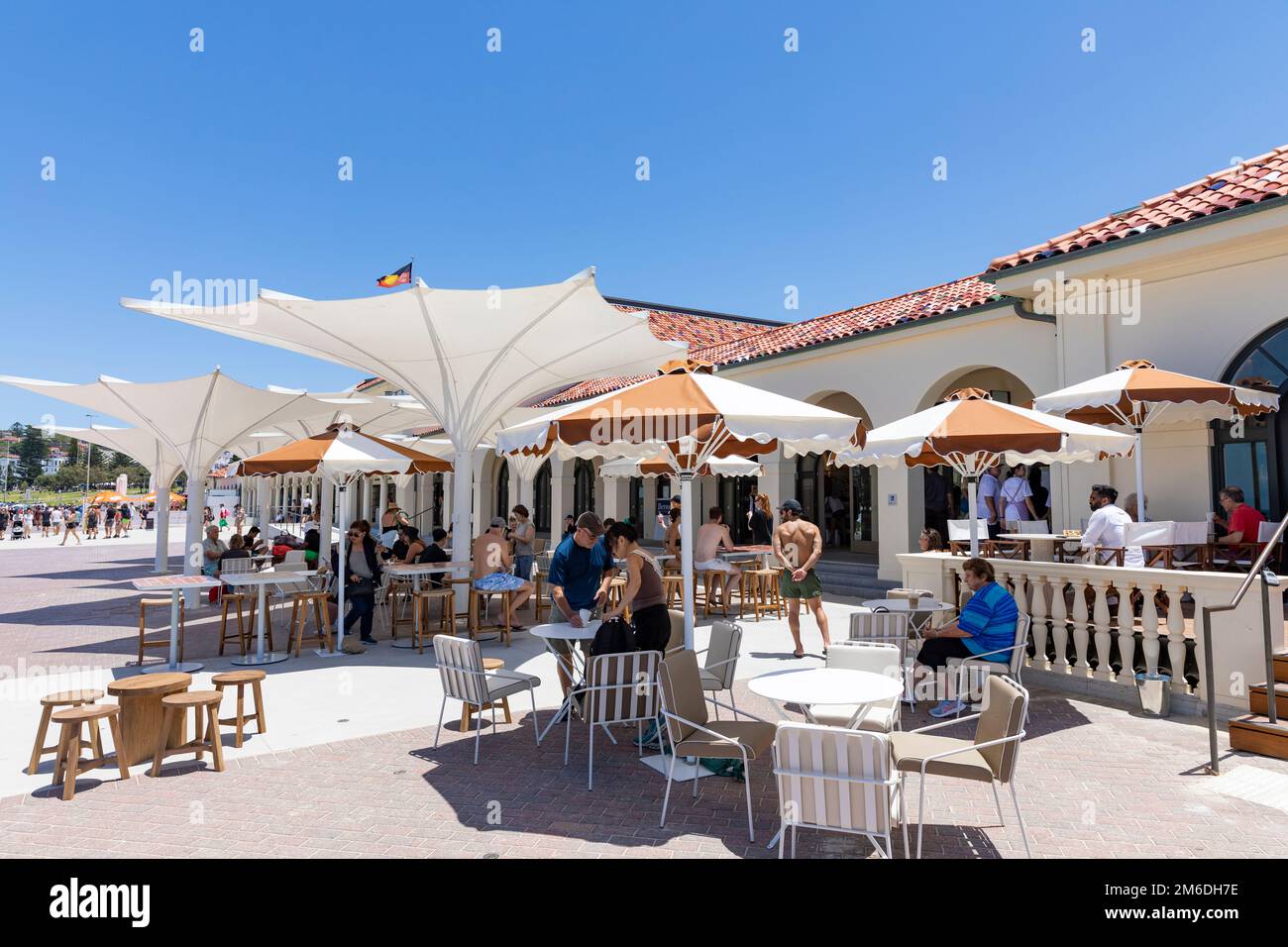 Bondi Beach cafe on the promenade, people sitting under parasols for shade,Bondi,Sydney Bondi Beach cafe on the promenade, people sitting under parasols for shade,Bondi,Sydney