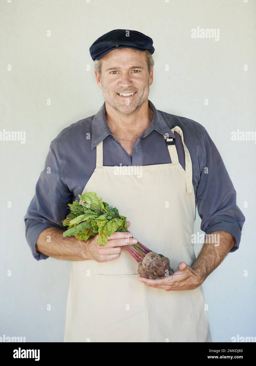 All the vitamins in one vegetable. A mature man holding a bunch of beetroot. Stock Photo