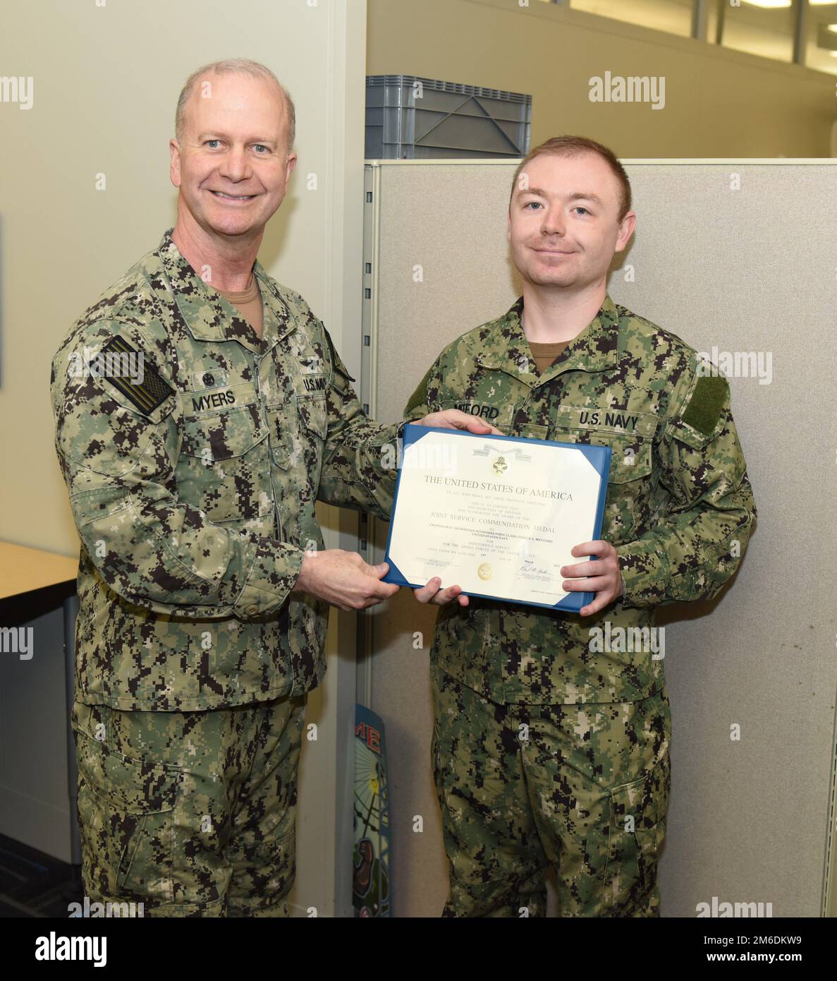FORT GEORGE G. MEADE, Md.---Petty Officer 1st Class Joshua Mefford received a Joint Service Commendation Medal on Apr. 25, 2022 for work that directly impacted national security on dozens of occasions, producing results that were included in several Presidential Briefs.  Vice Adm. Ross Myers, commander, U.S. Fleet Cyber Command/U.S. 10th Fleet, presented the award to Mefford at Computer Network Operations. Stock Photo