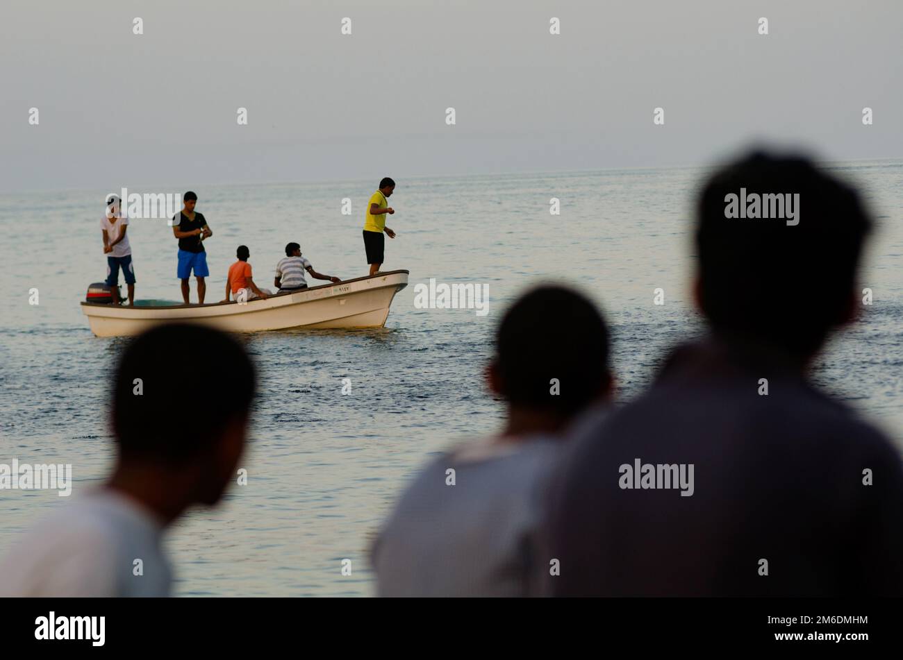 Young Omanis Fishing at Tiwi village, Oman Stock Photo