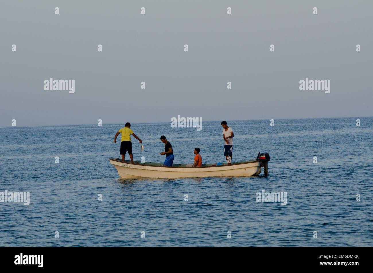 Young Omanis Fishing at Tiwi village, Oman Stock Photo