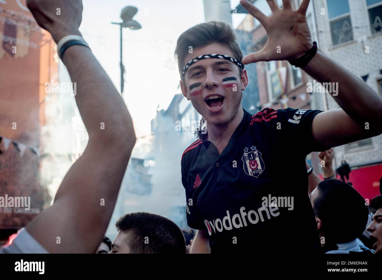Besiktas Carsi football supporters singing songs before a match in Istanbul, Turkey. Stock Photo