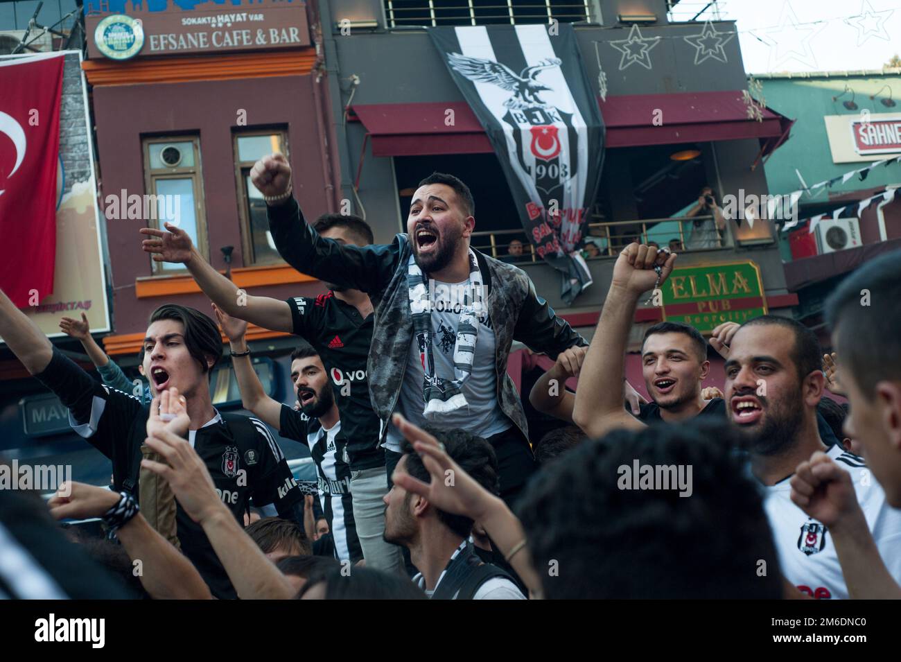 Besiktas Carsi football supporters singing songs before a match in Istanbul, Turkey. Stock Photo