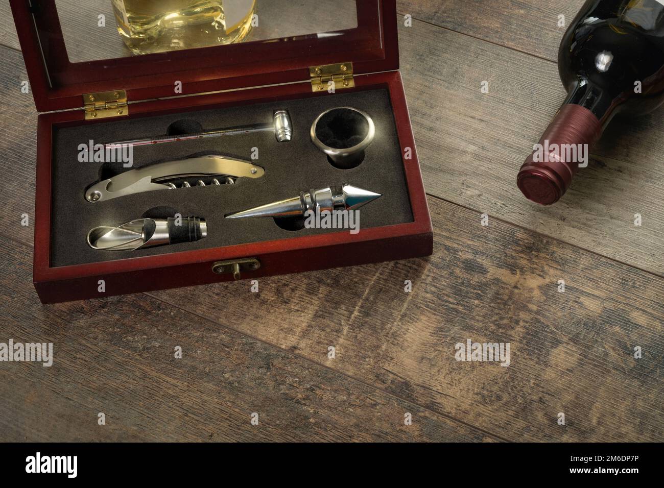 https://c8.alamy.com/comp/2M6DP7P/gift-set-for-opening-storing-and-controlling-wine-additional-stoppers-means-for-opening-a-corkscrew-a-thermometer-on-the-texture-table-close-up-2M6DP7P.jpg