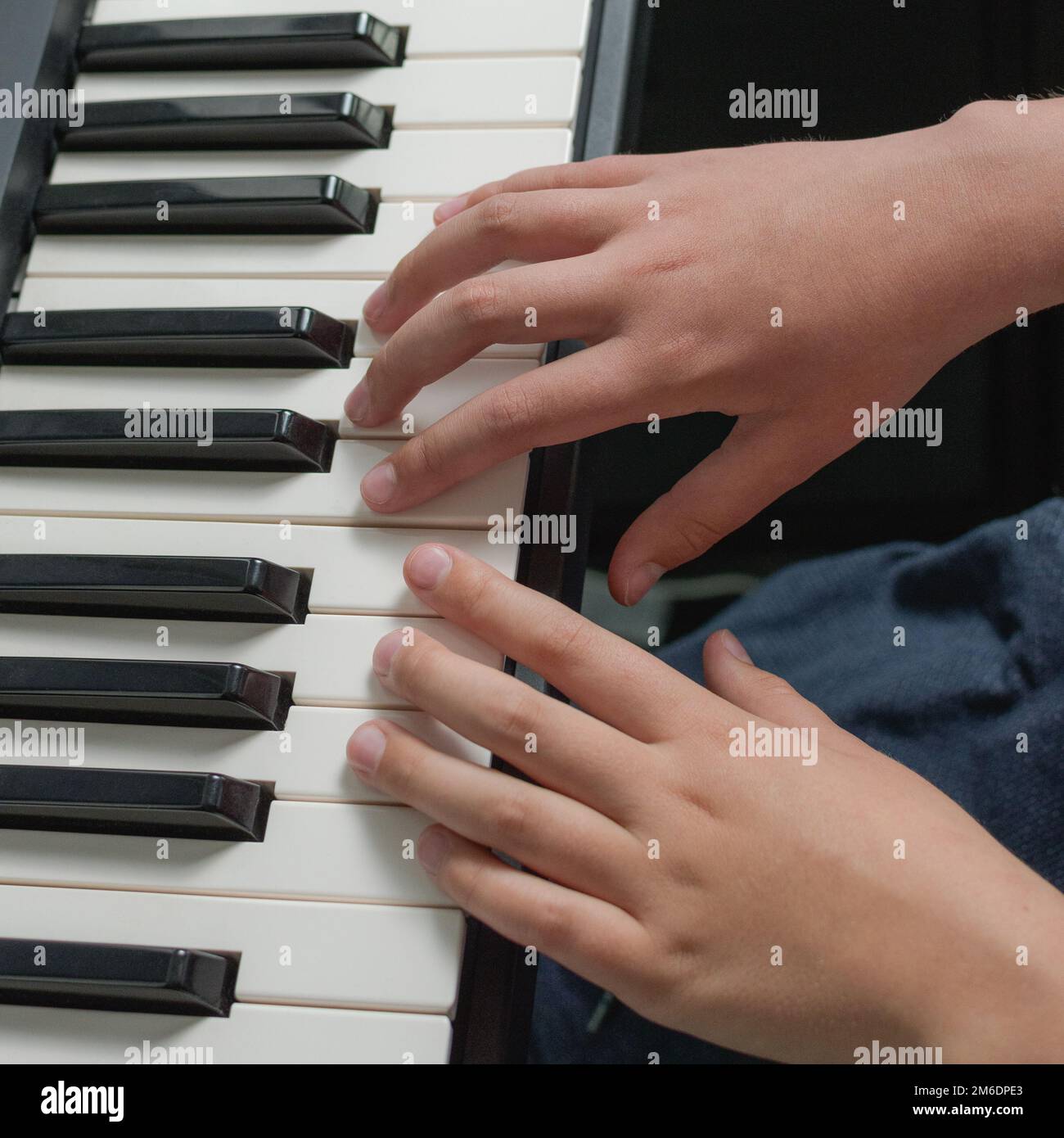 Music practice on piano keyboard. Two hands playing exercises. Chords