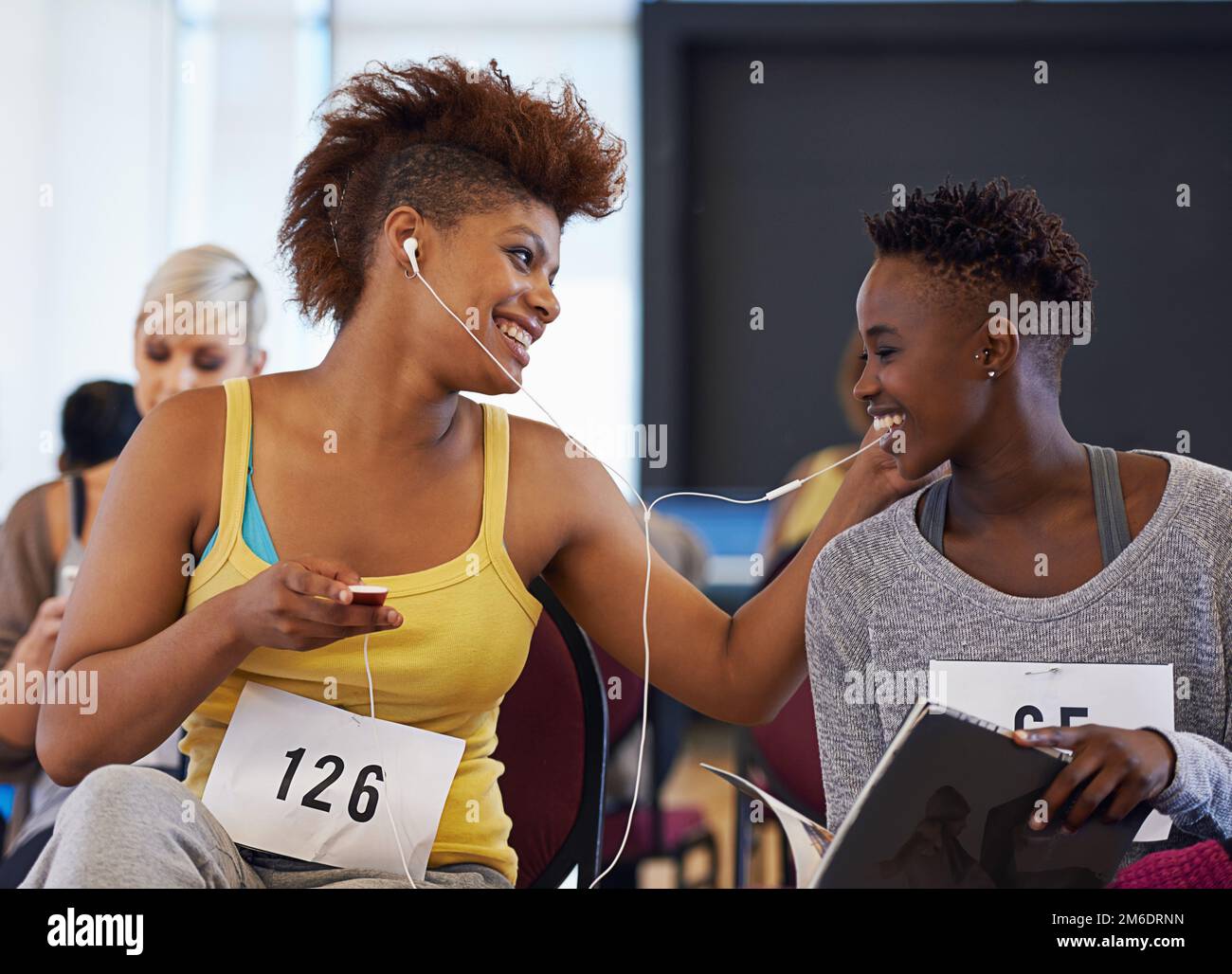 Sharing Some Tunes While They Wait Two Female Dancers Listening To