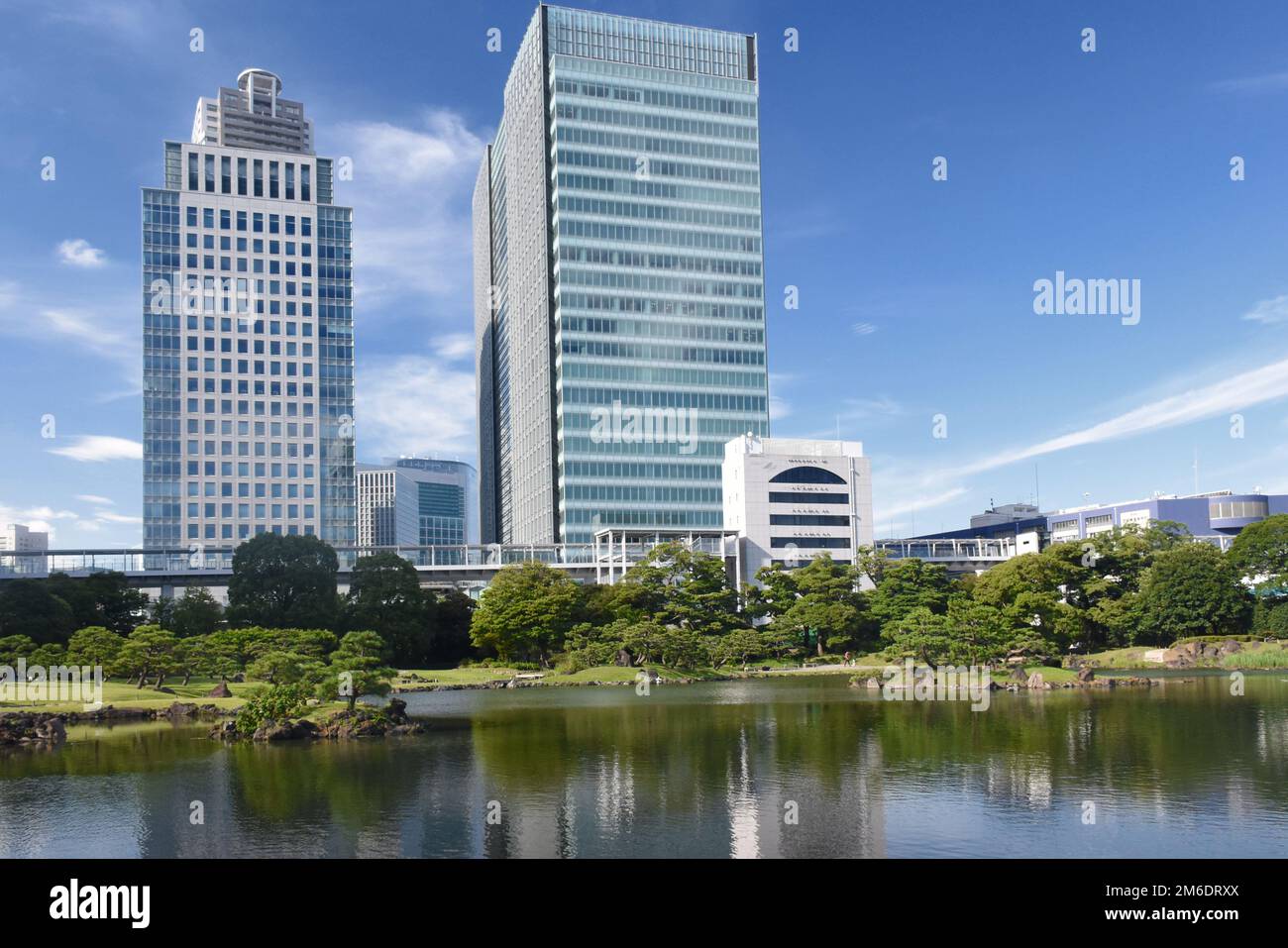 The Kyū Shiba Rikyū Garden - a public garden and former imperial garden in Minato ward in Tokyo, tall skyscrapers in the background Stock Photo