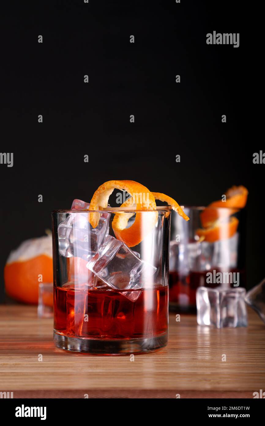 Chilled Alcohol Whisky / Rum Drink with Ice Cube and Orange Peel Stock