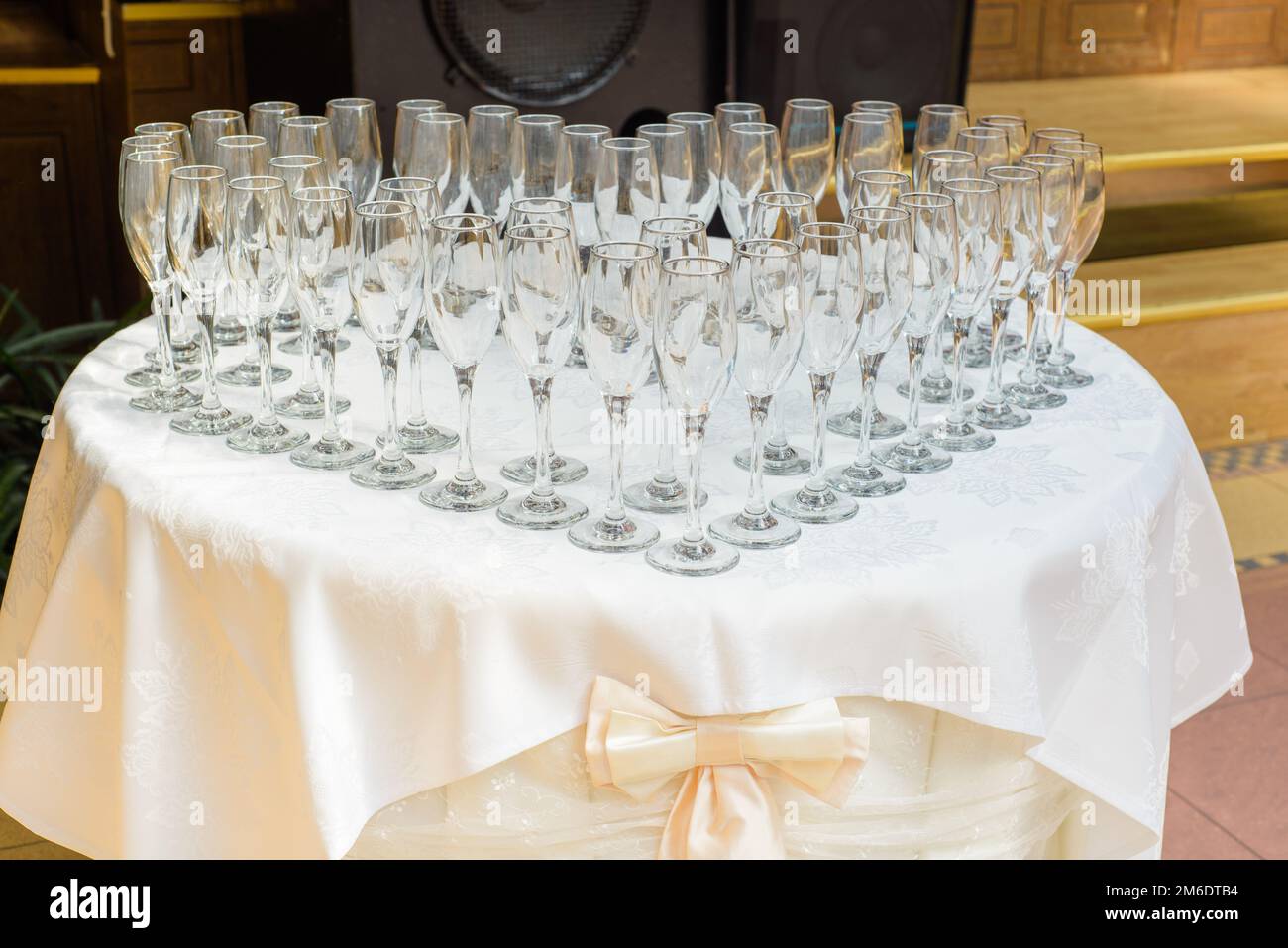 Table with champagne glasses, prepared for celebration Stock Photo - Alamy