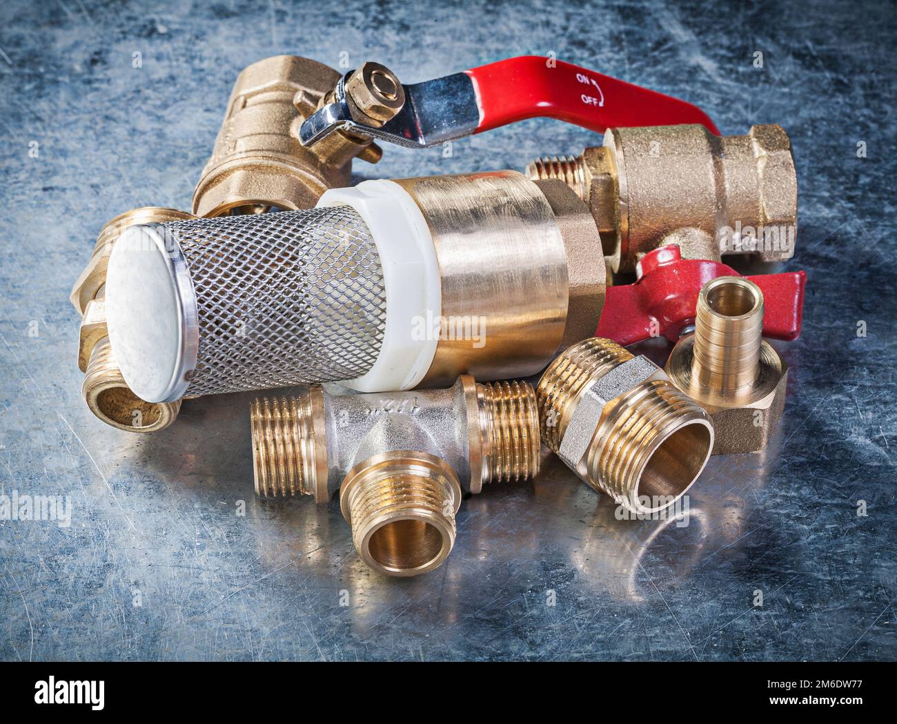 Brass nipple hose connectors lever ball valve with strainer filter on metallic background