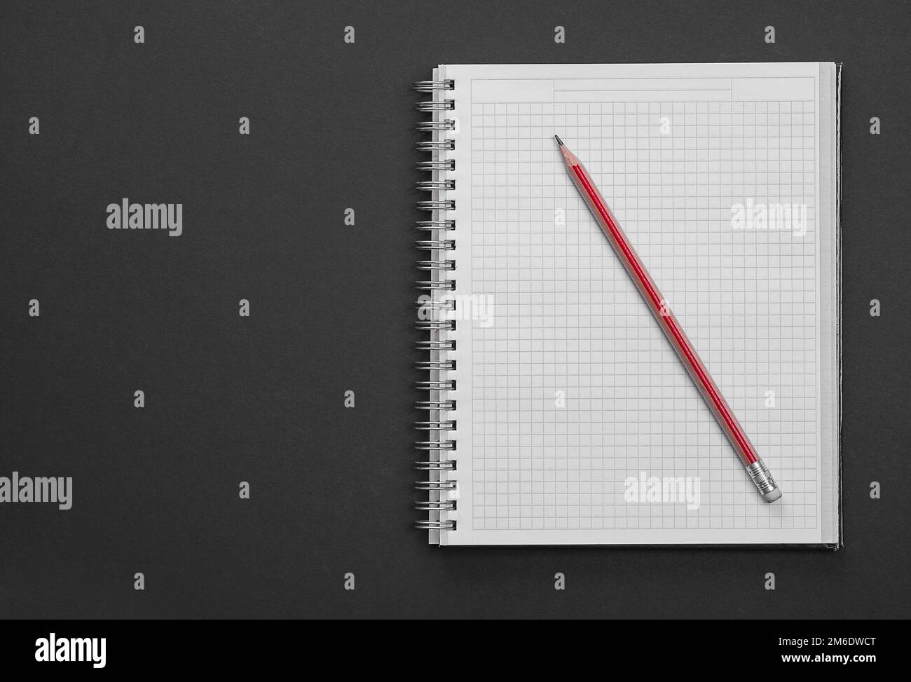 Clean squared copybook with red pencil on black background education ...