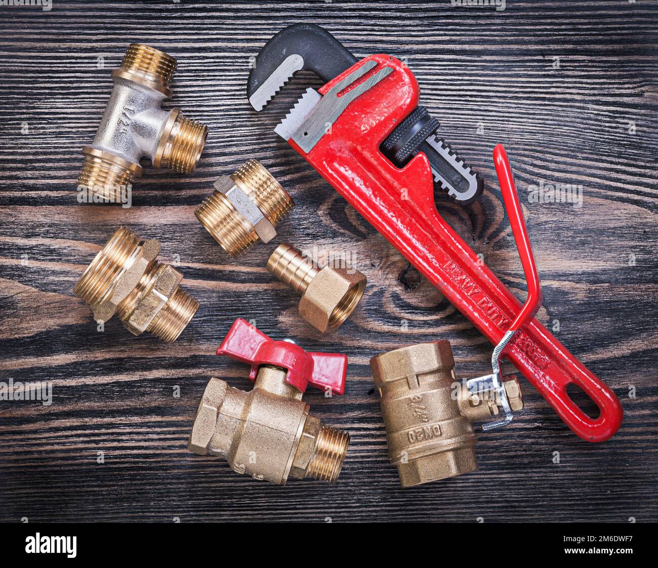 Collection of adjustable pipe wrench brass fittings water valve on wood ...